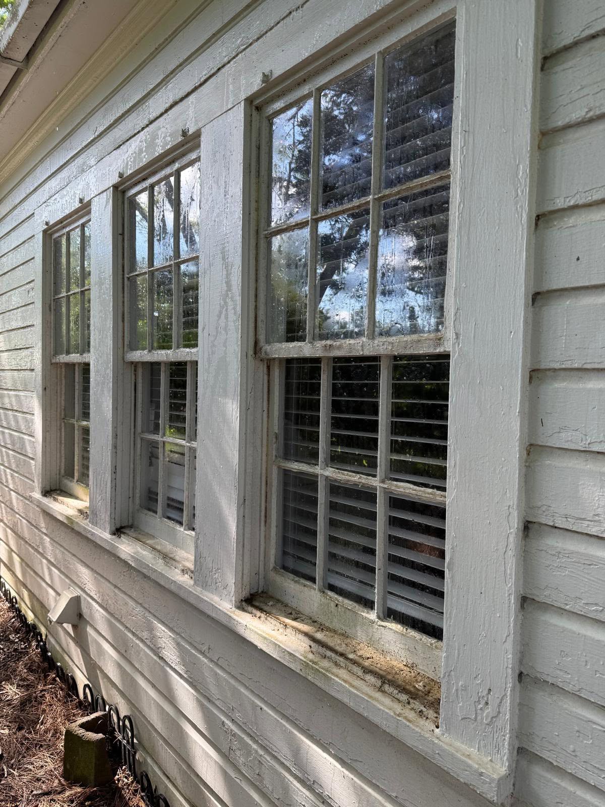 Weathered exterior window trim before restoration and painting